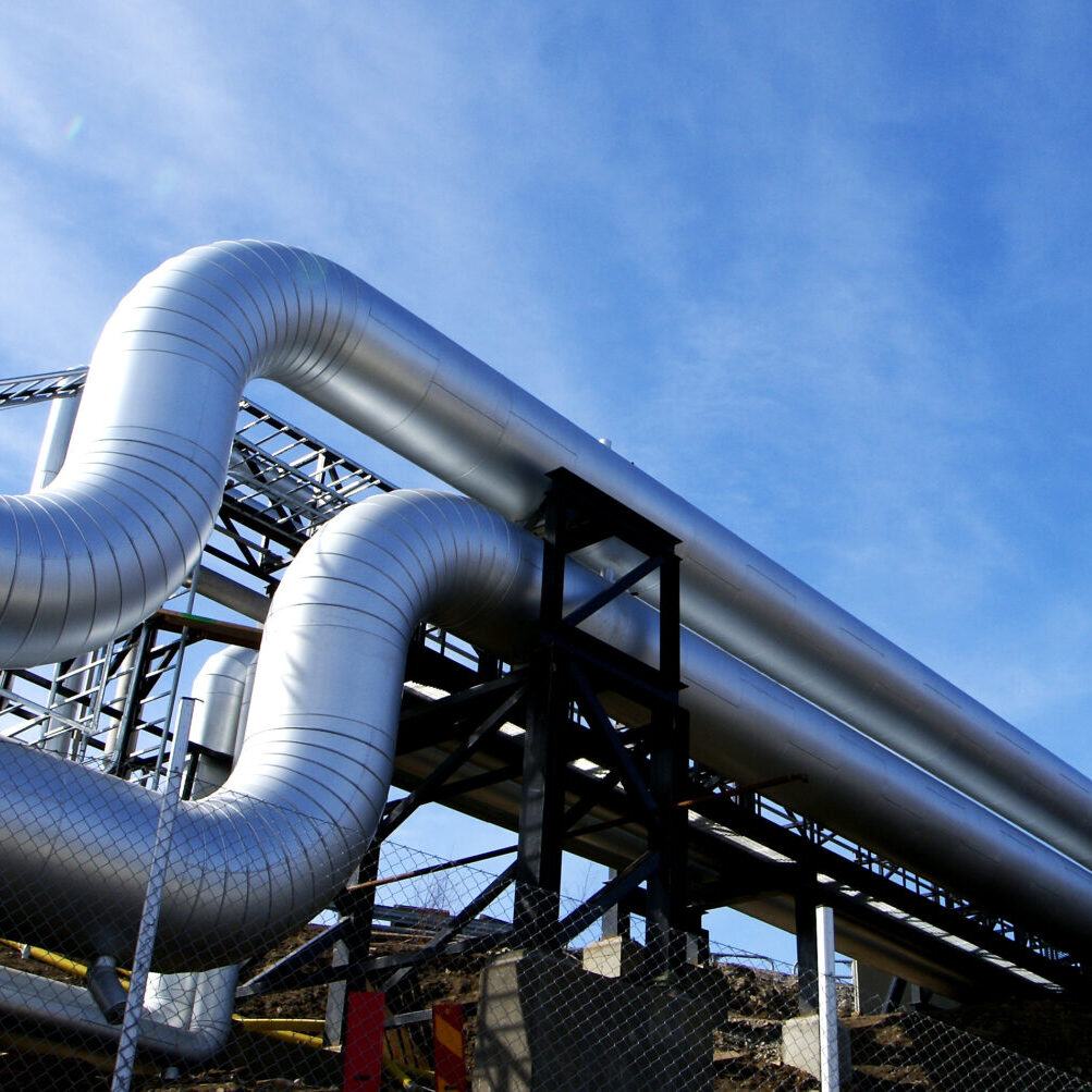 Industrial zone, Steel pipelines and valves against blue sky